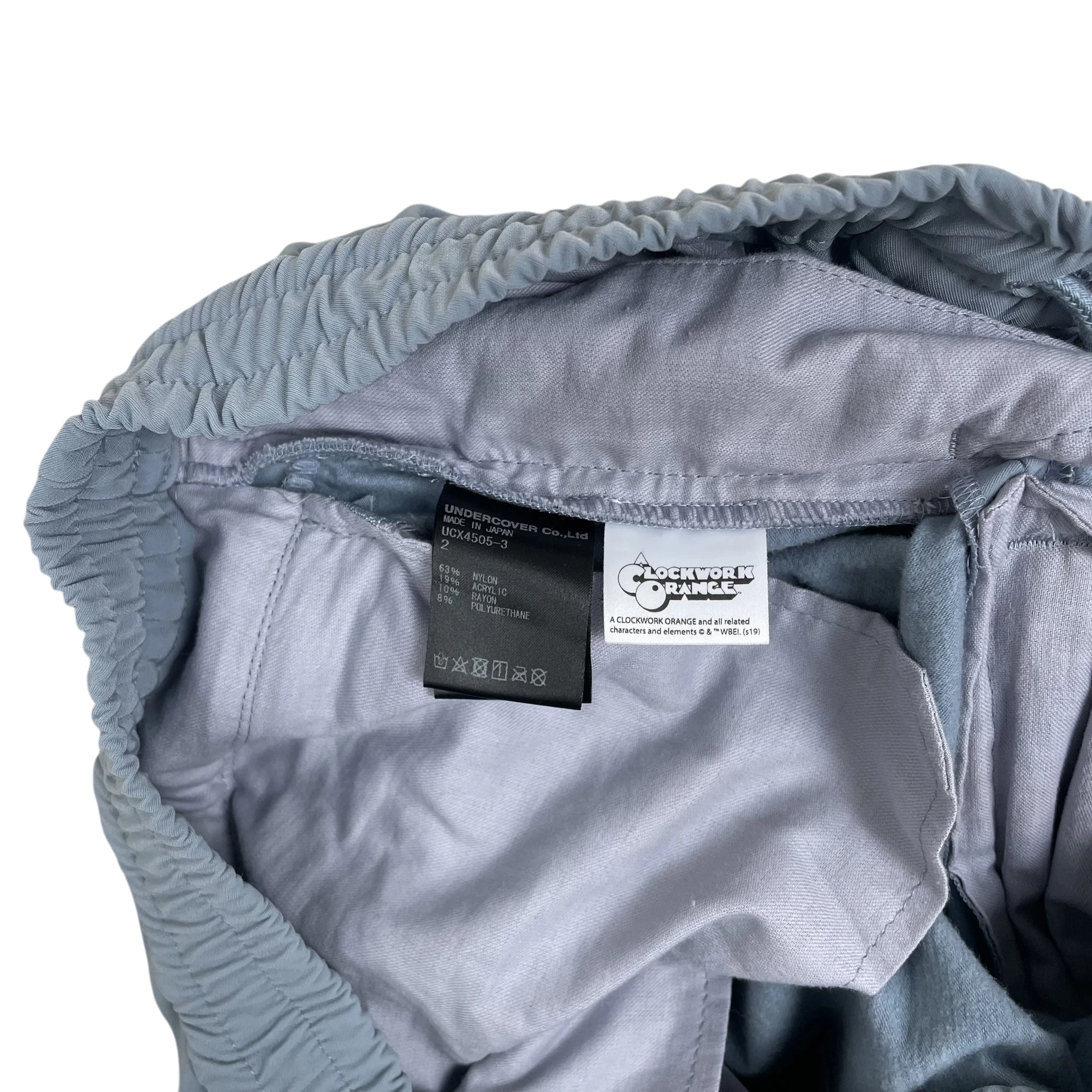 Zenno Archive Undercover Jun Takahashi A Clockwork Orange track pants interior label detail in baby blue