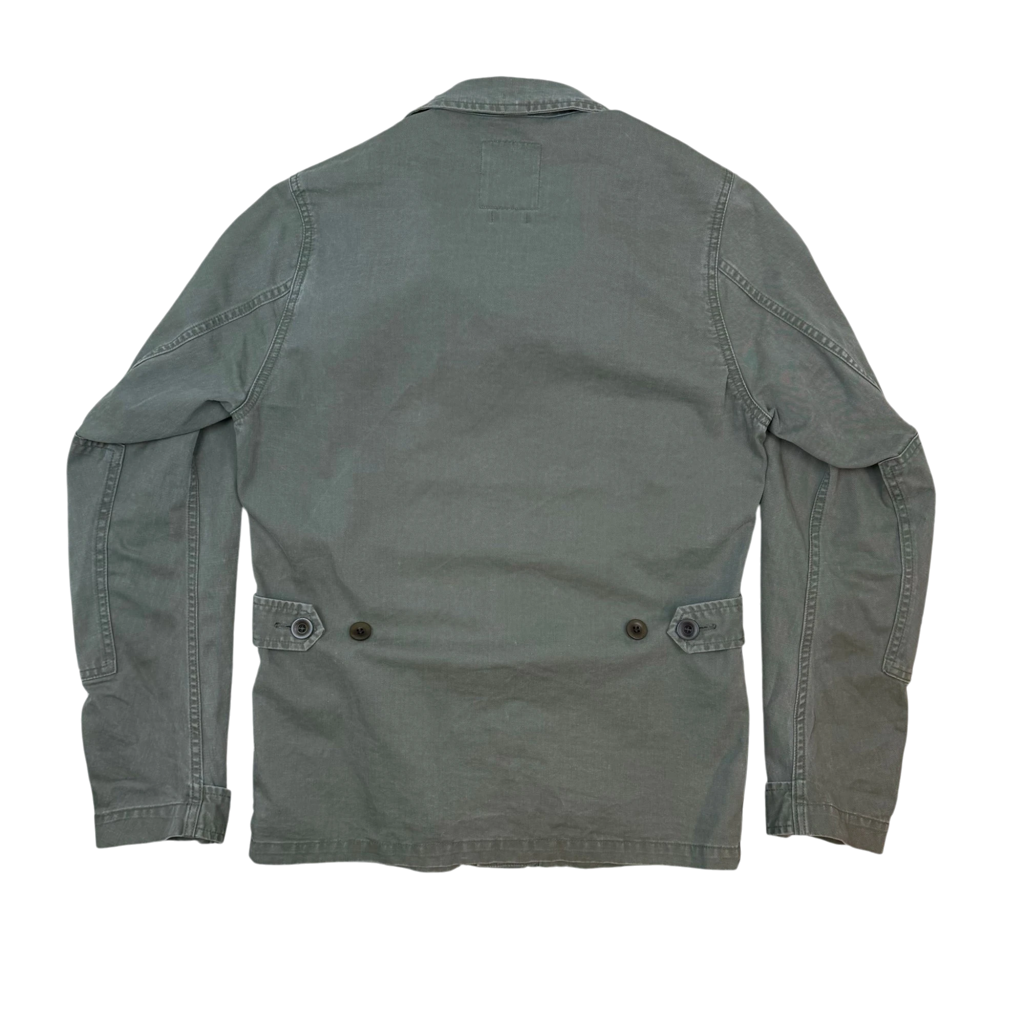 Back view of a Zenno Archive Visvim SS15 olive green four-pocket Kilgore military jacket with buttoned waist tabs.